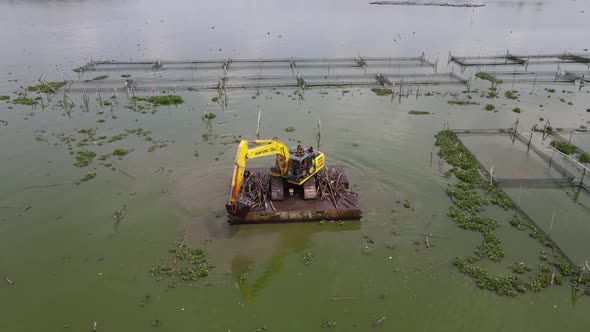 aerial view of crane in traditional floating fish pond on swamp in Indonesia