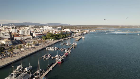 Yacht and motorboats docked at piers along Ribeirinha, Portimao, Algarve, Portugal