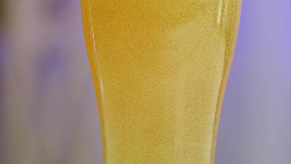 Cold Light Beer in a Glass on a Bluish Blurred Background