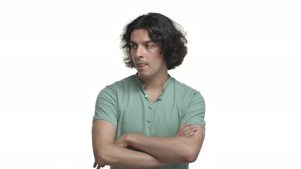 Skeptical and Judgemental Hispanic Man Nodding Cross Arms Chest and Looking with Disbelief Standing