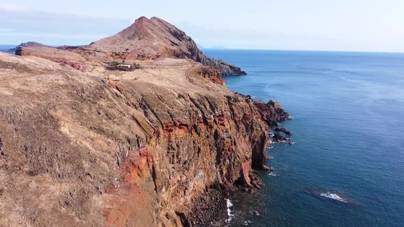 Beautiful island in the middle of the Ocean. Vibrant colors. Waves crashing against the cliffs.