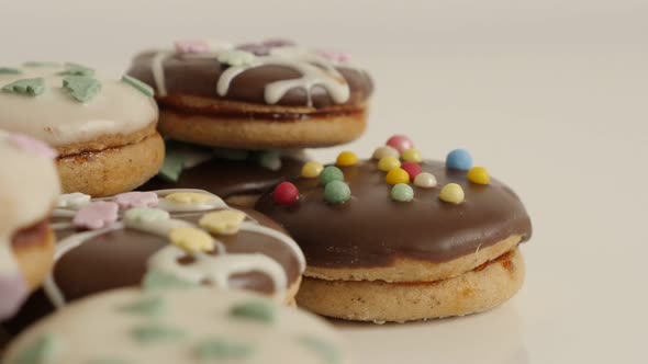 Colorful cookies with sprinkles slow tilt 4K 2160p 30fps UltraHD footage - Stuffed teacakes on pile 