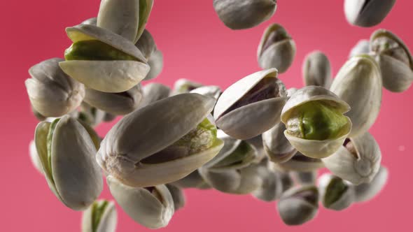 Flying of Pistachios in Light Fuchsia Background