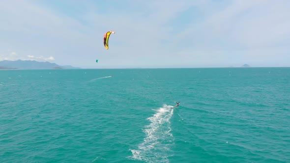 Acrobatic Jump of Professional Kite Surfer on the Sea Wave, Athlete Showing Sport Trick Jumping 