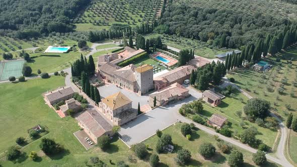 Fly over footage of a castle hotel in Tuscany, Italy.