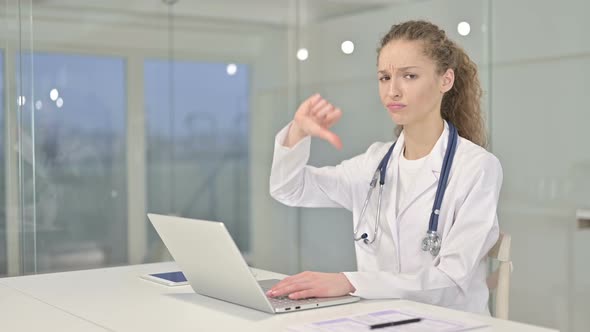 Ambitious Young Female Doctor Doing Thumbs Up in Office 