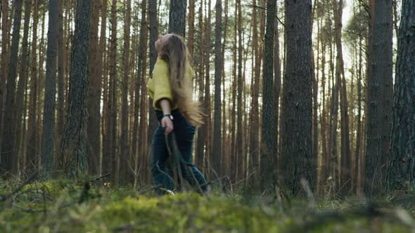 Beautiful Girl in the Forest with Long Hair Smiling