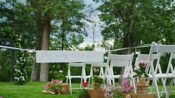 Green Lawn with Rows of White Wooden Chairs