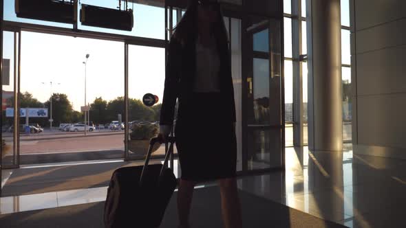 Business Lady Going to the Airport with Her Luggage