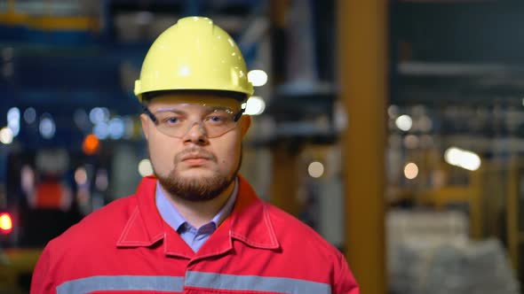 Handsome Engineer Walking in a Factory