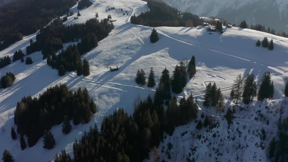 Aerial of cabins on top of snow covered mountain