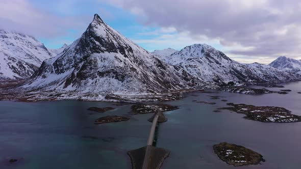 Fredvang Bridge and Volandstind Mountain in Winter. Lofoten, Norway. Aerial View