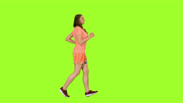 Young Woman Jogging on Green Background, Chroma Key