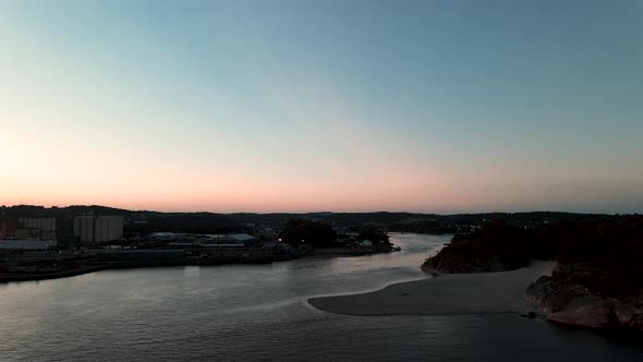 The river Logen pouring into the ocean in Larvik Norway during a beautiful sunset