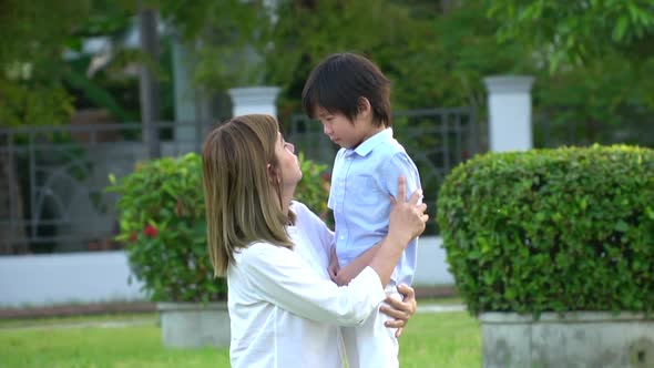 Asian Mother Embracing And Consoling Her Son