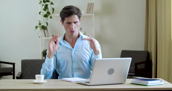 Portrait of Happy Businessman Sitting in Office or at Home at Table, Working at Laptop Online