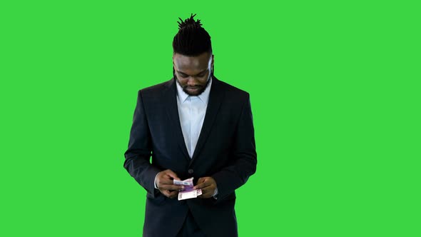 Black Man in Office Suit Walk Counting Money on a Green Screen Chroma Key