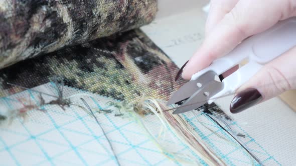 Cross-stitching. Woman embroiders cross-stitch. 