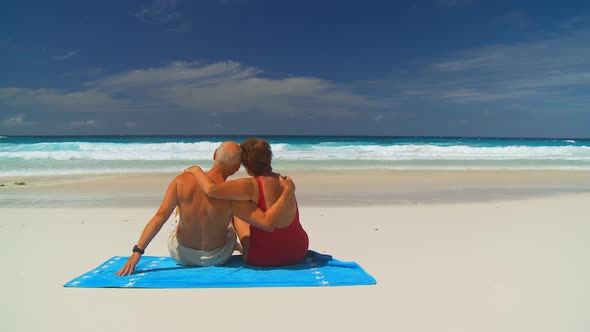 Elderly Couple Hugging on Beachtowel