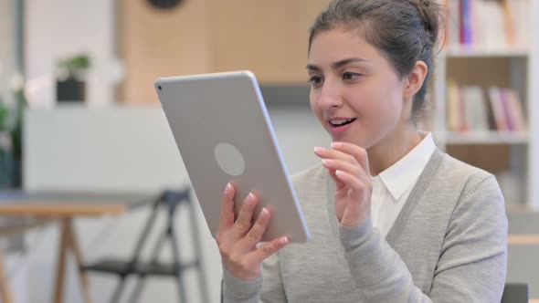 Happy Indian Woman Having Success on Tablet