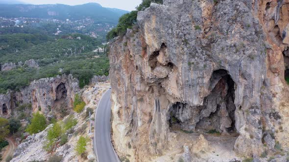Spectacular View of Steep Rocky Cliff Above Mountain Road