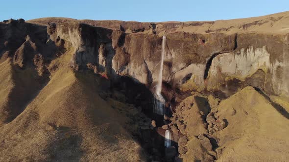 Aerial Shot of a High Waterfall Falling over a Cliff Edge.