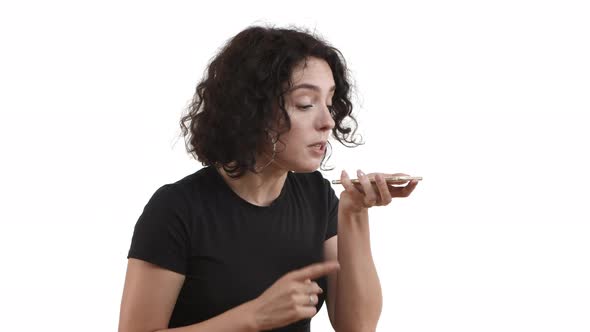 Attractive Young Woman with Short Curly Hair Wearing Casual Black Tshirt Having Intense Conversation