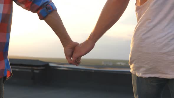 Camera Follow To Gay Couple Runs on Roof and Holding Hands of Each Other at Evening Time