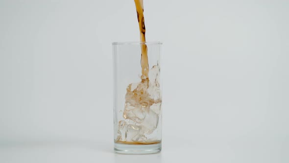 Slow Motion of Pouring Cola in Glass with Ice White Background