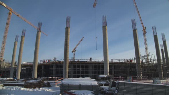 High Tower Cranes at Construction Site of Sports Stadium