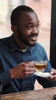 African American Man Drinking Tea in the Restaurant