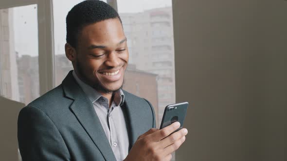 Excited Black Man Working in Digital App Hold Smartphone Read Good Internet News Happy African Guy