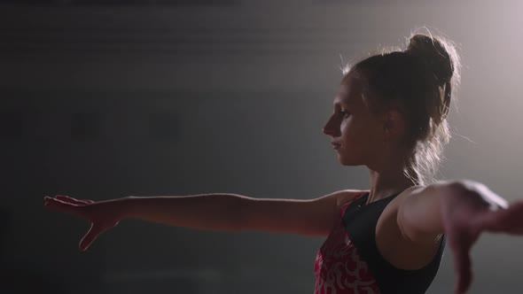 Portrait of Concentrated Sporty Teen Girl on Floor for Performance of Gymnastics Training