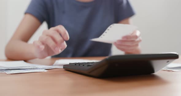 Housewife Woman use of calculator for daily expense