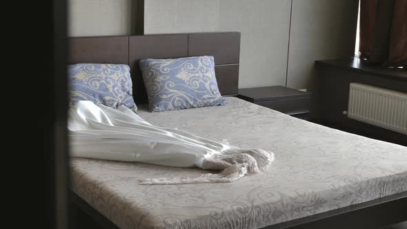 Wedding Dress Lies on the Bed Before the Wedding