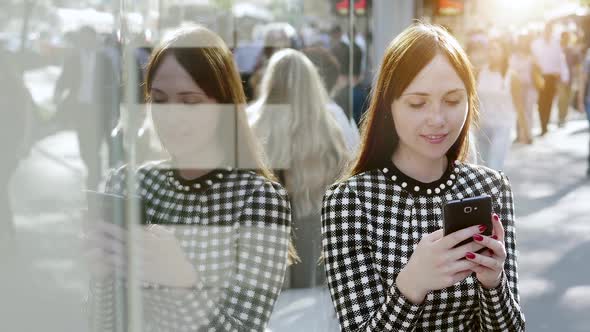 Attractive Young Woman using Smart Phone in the City