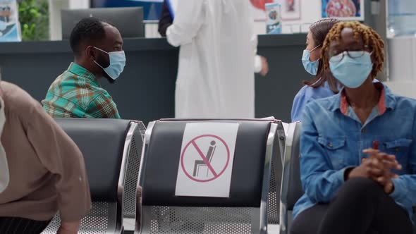 Multiethnic Group of People with Face Masks Sitting in Waiting Area