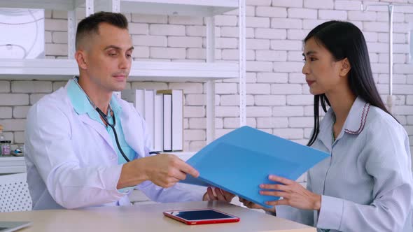 Doctor in Professional Uniform Examining Patient at Hospital