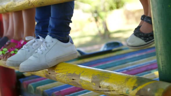 Kids standing on a wooden pole