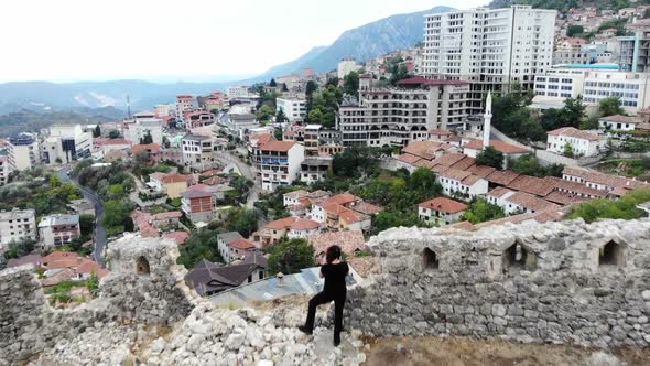 Woman Traveller Investigating Old Ruins in Ancient Castle, Discover History, Aerial Shot From Drone