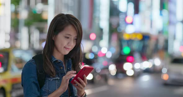 Woman use of mobile phone in Tokyo city at night