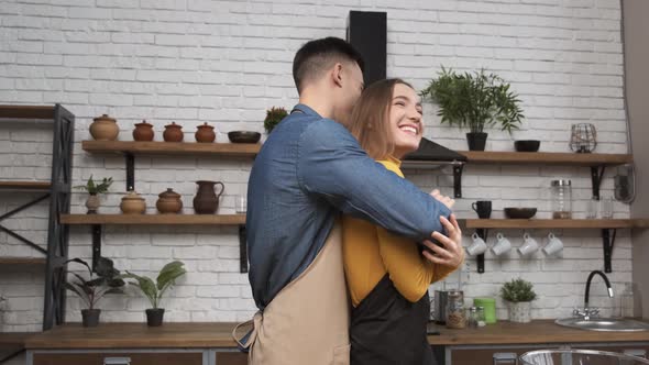 Cooking Salad at Home Young Couple Laughing and Fooling Around with Vegetables in Modern Kitchen