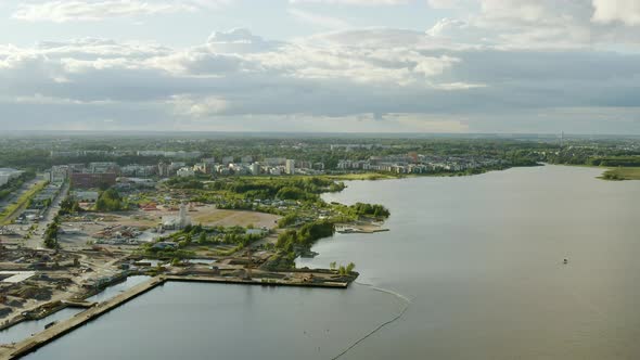 Aerial view of Verkkosaari and Kylasaari areas, partly sunny day, in Helsinki, Finland - pan, drone