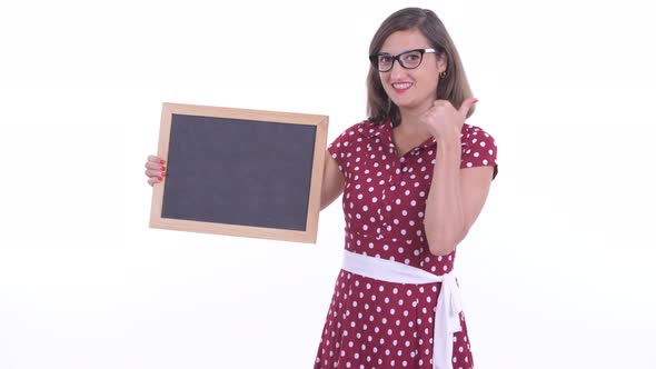 Happy Beautiful Woman with Eyeglasses Holding Blackboard and Giving Thumbs Up