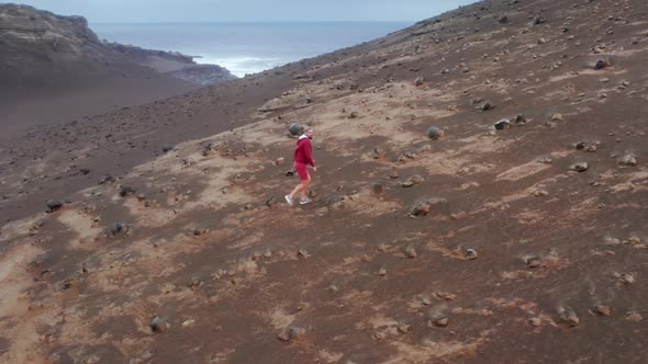 Aerial Footage of a Man Strolling Across the Volcano