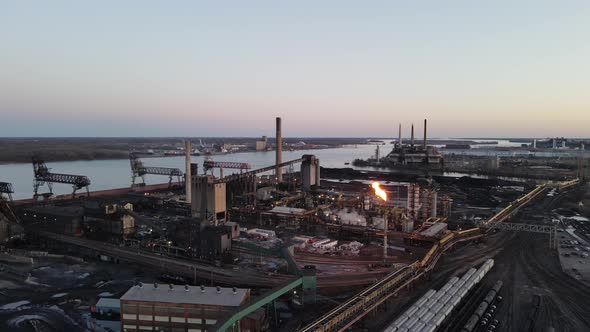 Steel mill at Zug island producing iron, dolly forward aerial shot, Detroit, Michigan.