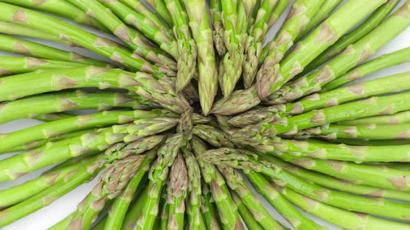 Green asparagus on a light table, rotation. Fresh and tasty organic asparagus