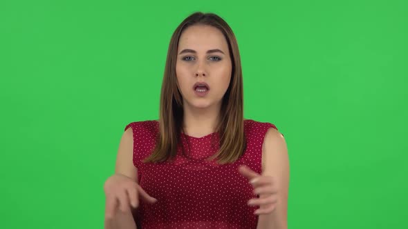 Portrait of Tender Girl in Red Dress Is Clapping Her Hands Indifferent. Green Screen