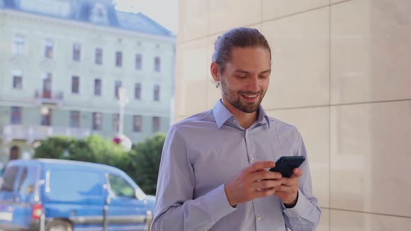 Man Using Mobile Phone, Messaging At City Street