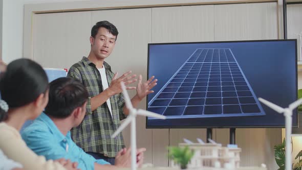 Asian Man Engineer Presenting About The Work Of Solar Cell To His Colleagues At The Office